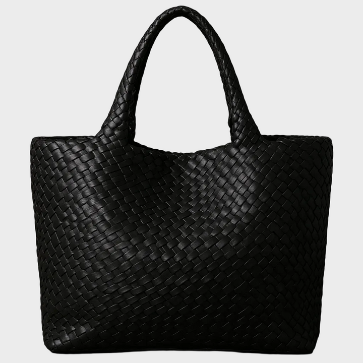 Women's handwoven leather large tote bag carried by a woman. Stylish everyday shoulder bag for work or leisure.