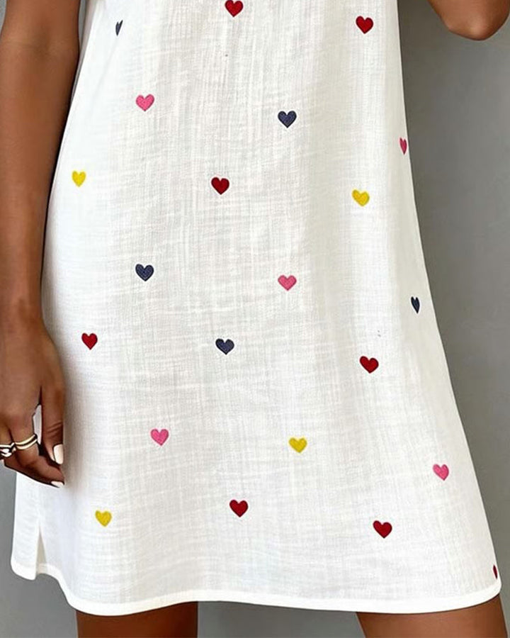 Stylish women's casual heart print mini dress. Features a V-neck, puff sleeves, & relaxed fit for vacation.