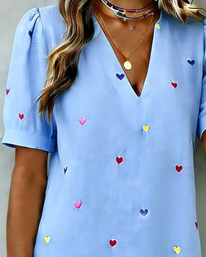 Full view of women's heart print casual V-neck mini dress. Features puff sleeves and a comfortable relaxed fit.