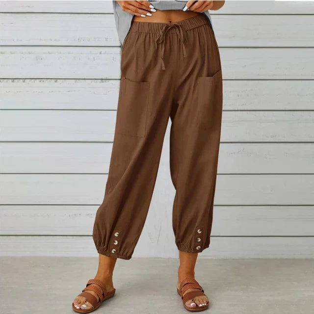 Women's fashion pants: high waist, drawstring, tapered leg, and stylish button cuff detail.