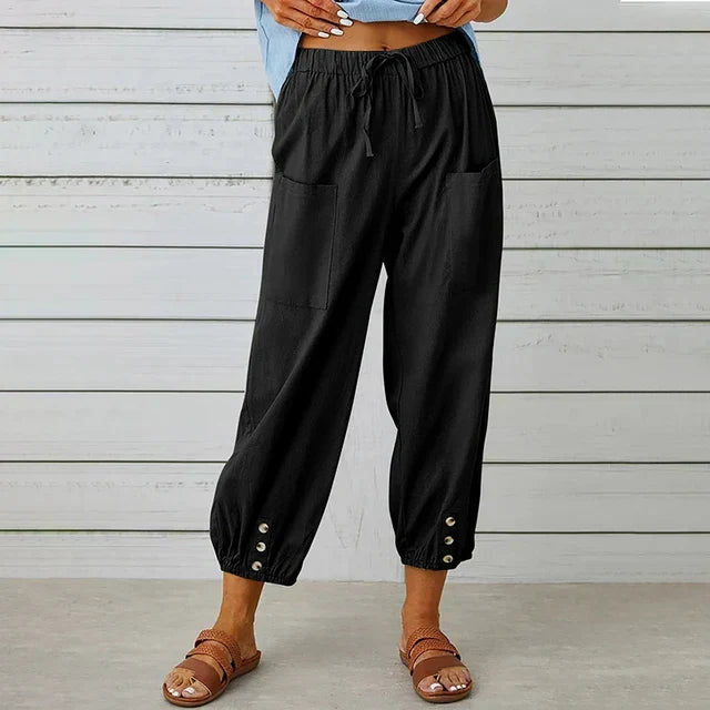 Fashionable women's tapered ankle pants with elastic high waist and adjustable drawstring.