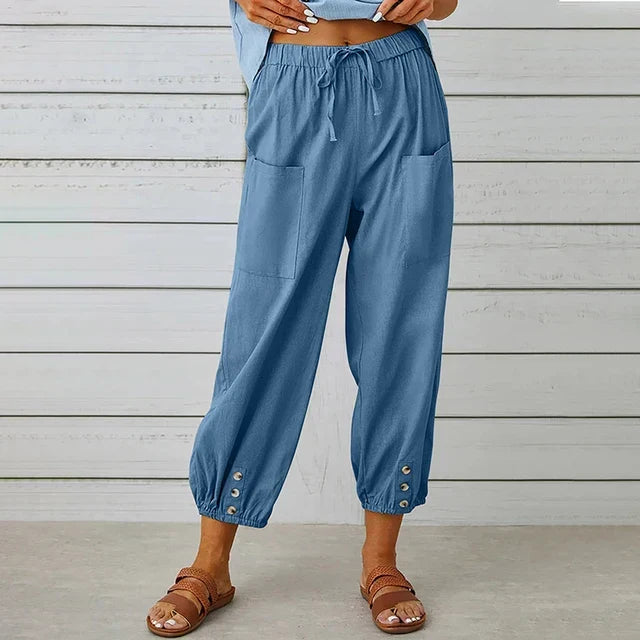 Casual women's pants featuring a high waist, drawstring, tapered leg, and button cuff details.