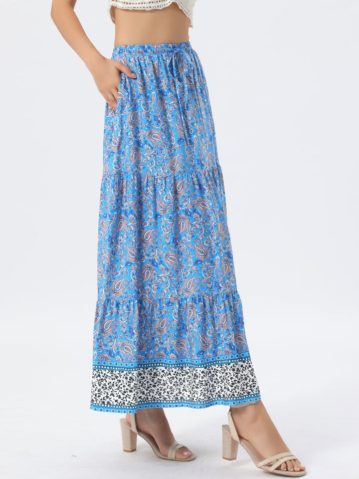 Women's printed high-waist flowing maxi skirt, showcasing its elegant side slit.