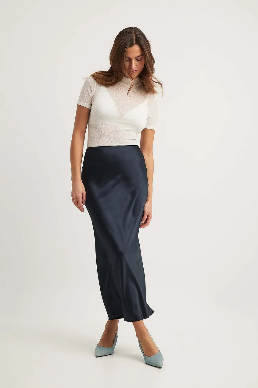 Flowing satin high-waist midi skirt for women, embodying versatile and elegant fashion.