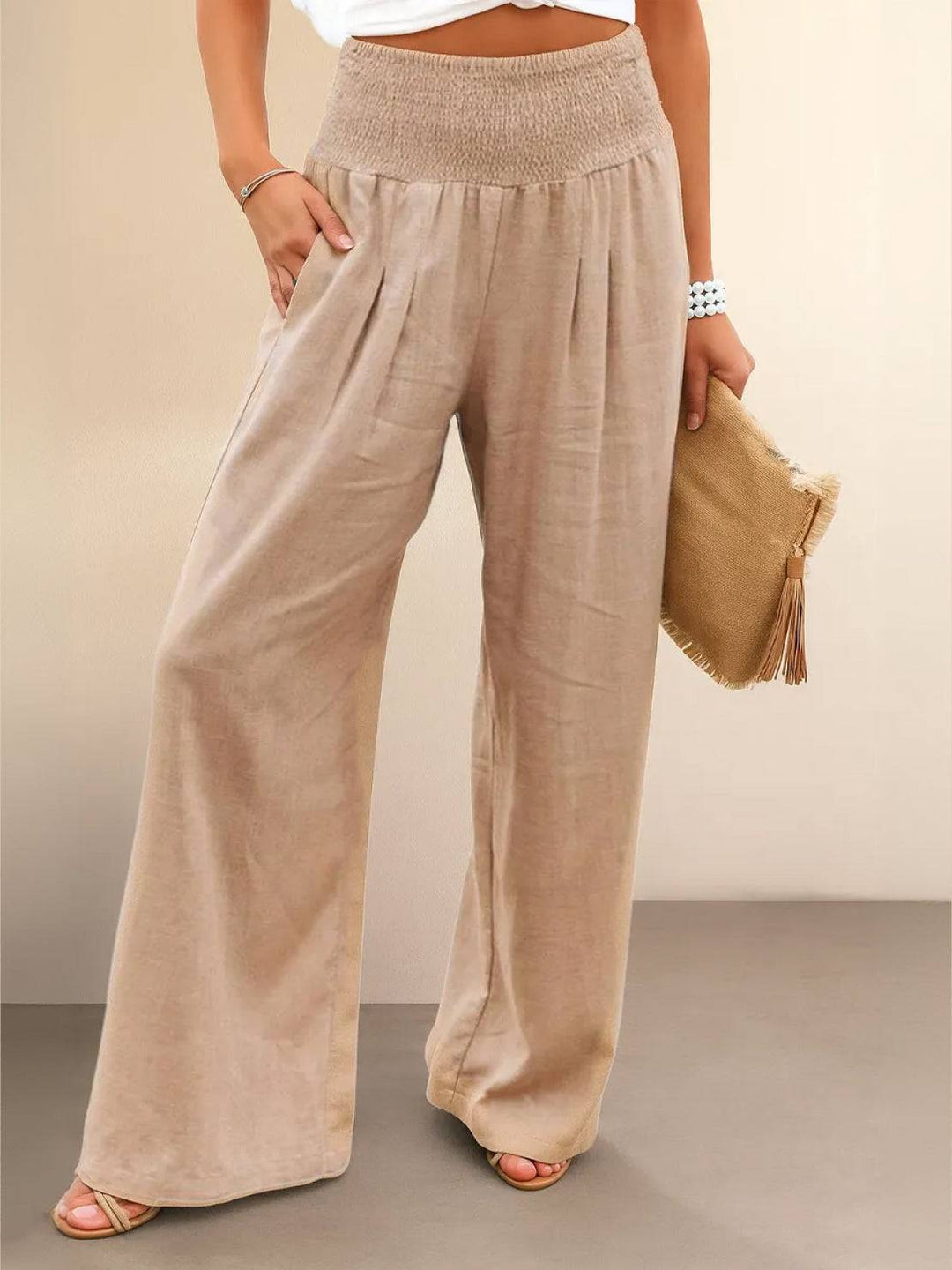 Women's high waist wide leg smocked trousers with a relaxed, flowy fit for summer comfort.
