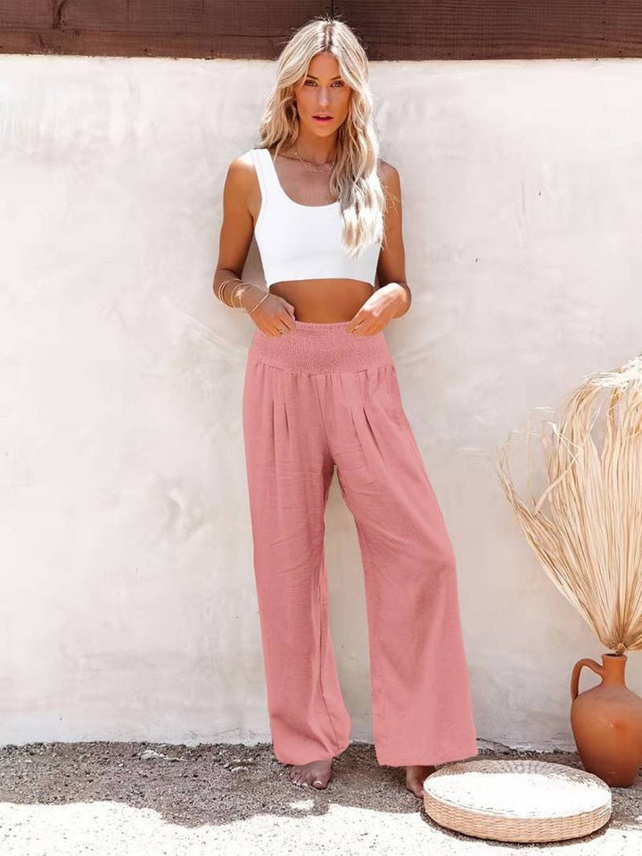 Women's relaxed wide leg trousers with a smocked high waist, suitable for casual chic spring fashion.