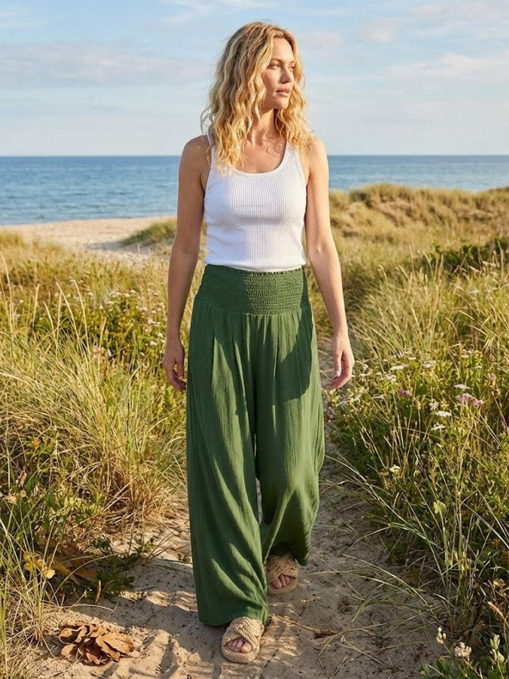 Smocked waist high rise wide leg trousers for women, ideal for spring comfort and stylish outings.