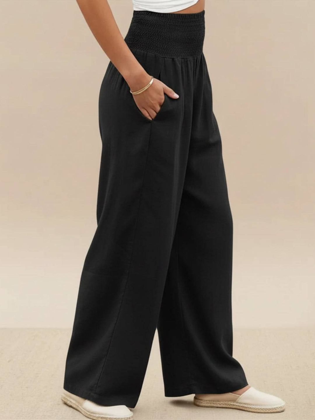 Stylish smocked waist wide leg pants for women, comfortable for spring/summer and casual outfits.