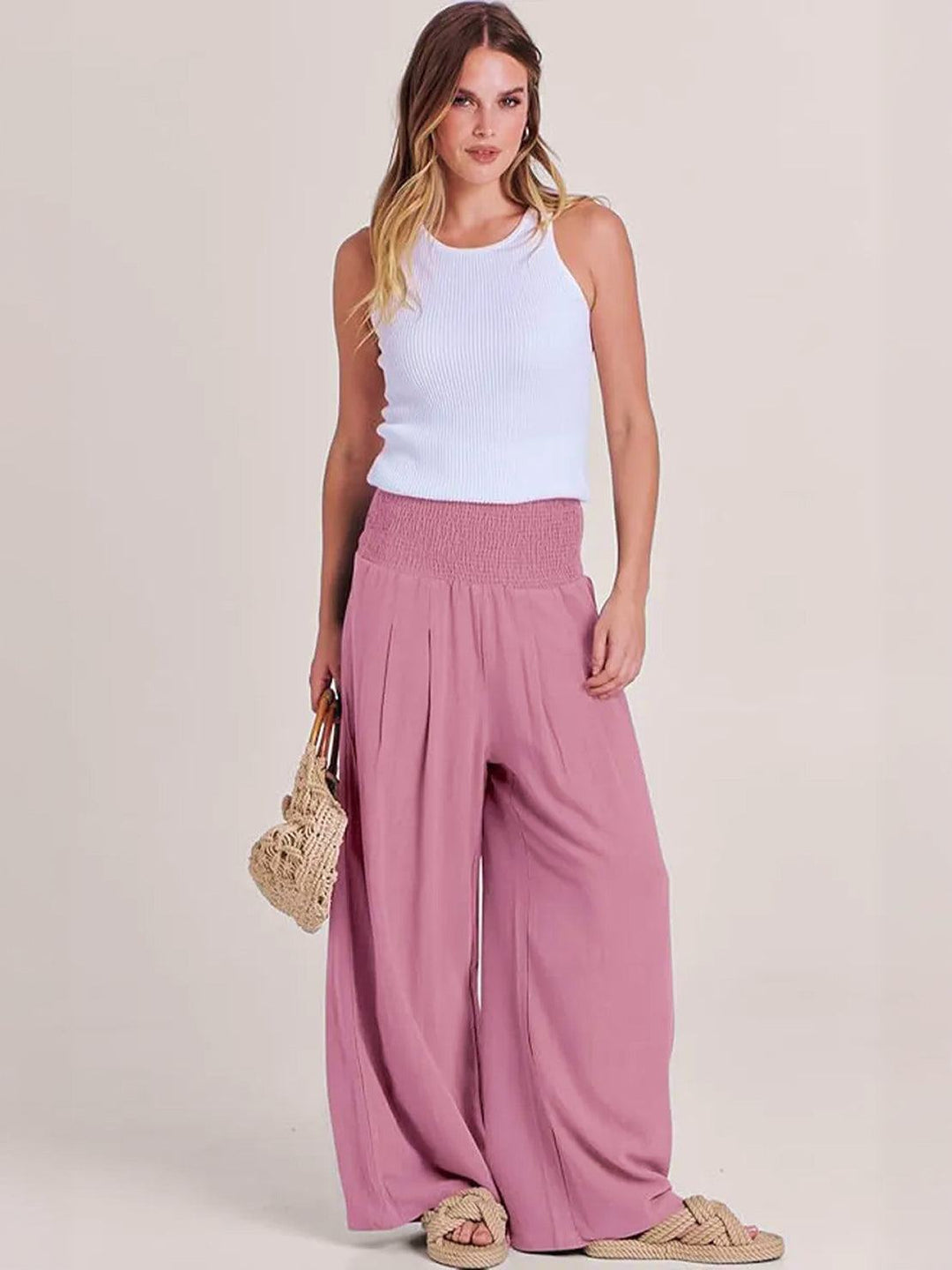 Chic women's smocked high waist wide leg trousers, perfect for relaxed summer days and casual wear.