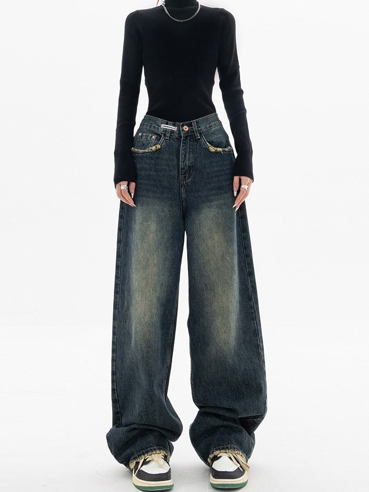 Stylish women's wide-leg denim jeans with a high waist and distressed details