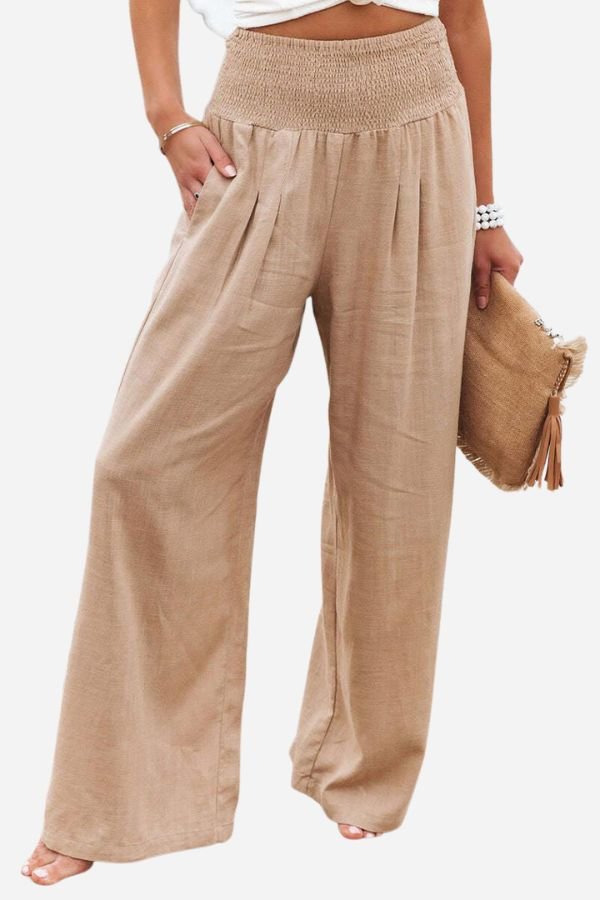Elegant women's wide-leg linen pants with smocked waist, ideal for summer beachwear or casual outings.