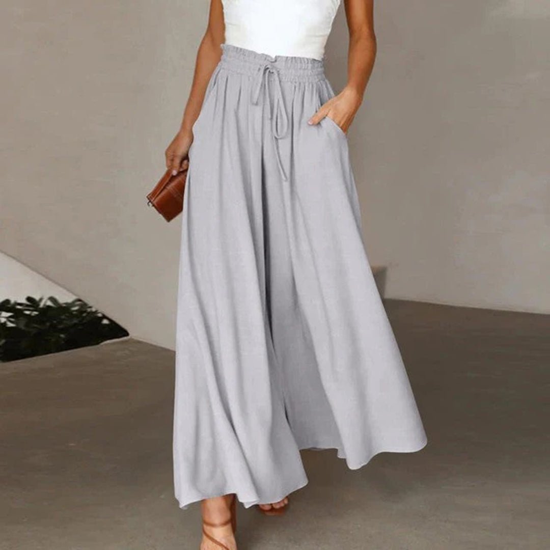 Women's high waisted wide leg palazzo pants featuring a drawstring waist & flowing comfort.