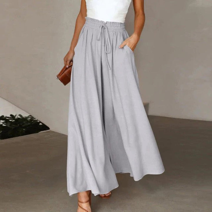 Women's high waisted wide leg palazzo pants featuring a drawstring waist & flowing comfort.