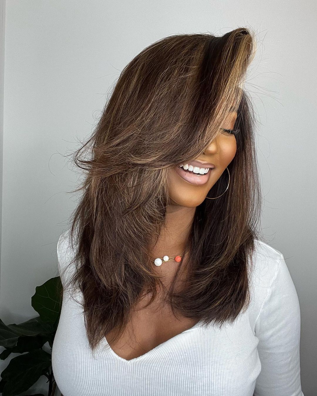 Elegant natural wave highlighted human hair wig for women. Dark brown base with blonde strands. Lace front.
