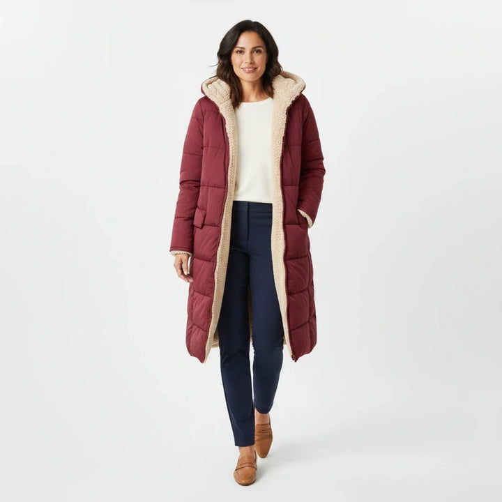 Women's hooded long puffer, insulated for cozy winter warmth and fashion.