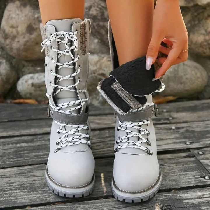 Side view of women's lace-up snow boots, insulated and waterproof, black color