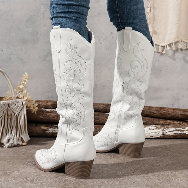 Women's knee-high cowboy boots with block heel and pointed toe.