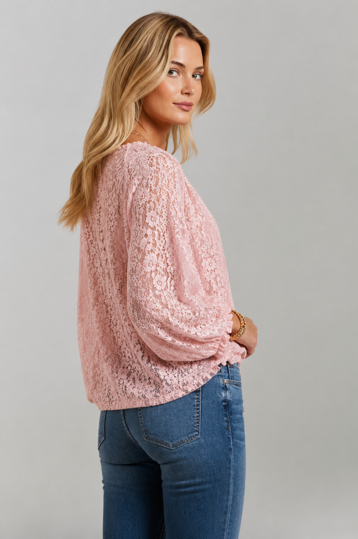 Women's pink long sleeve lace blouse with a graceful tied neckline, suitable for various occasions.