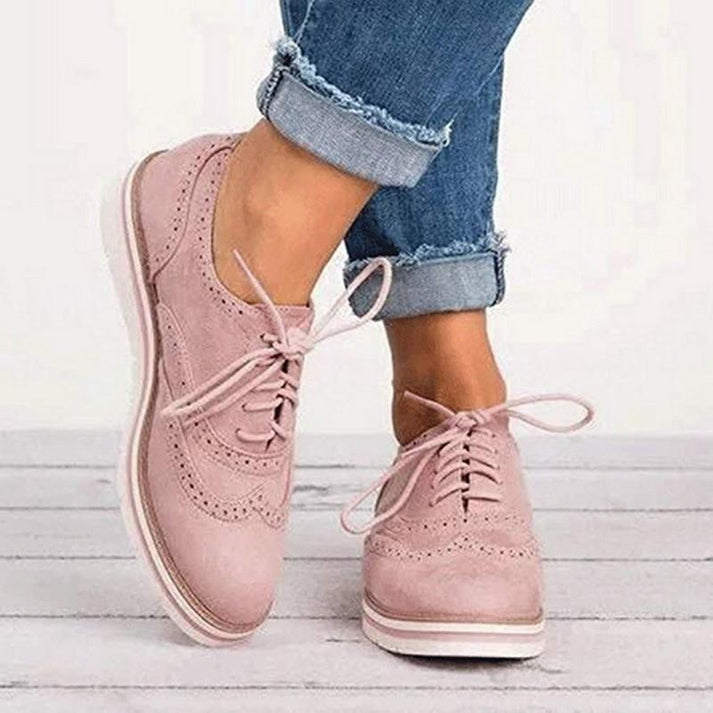 Women's lace-up oxford sneakers with brogue detail, perfect for smart casual or everyday comfort.