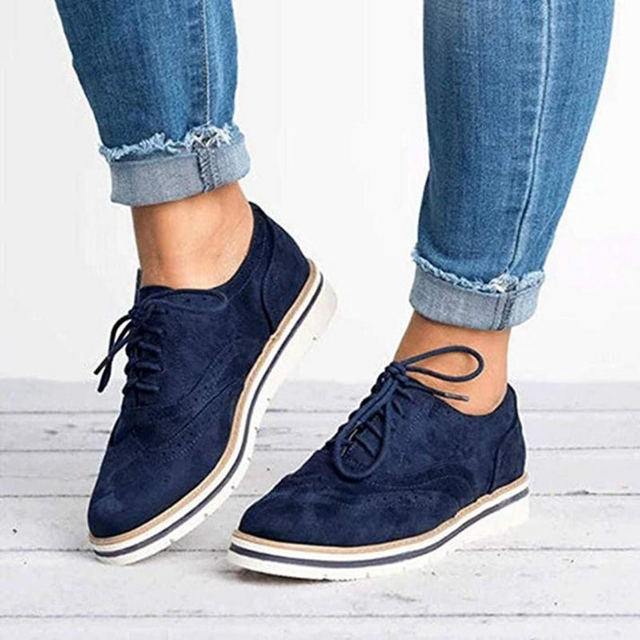 Casual women's sneakers featuring classic oxford style and brogue details for a chic, comfortable look.