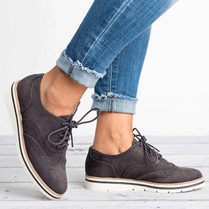 Comfortable women's lace-up sneakers in oxford style, ideal for versatile everyday smart casual footwear.