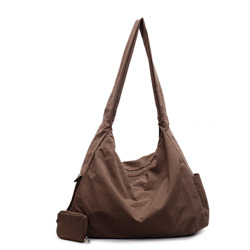 Women's casual crossbody bag with a wide, comfortable adjustable strap for shoulder or cross-body wear.