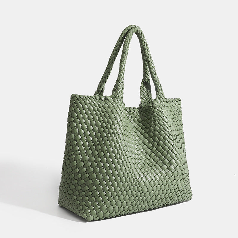 Fashionable women's large woven tote bag, chic shoulder carry for an elegant daily look.