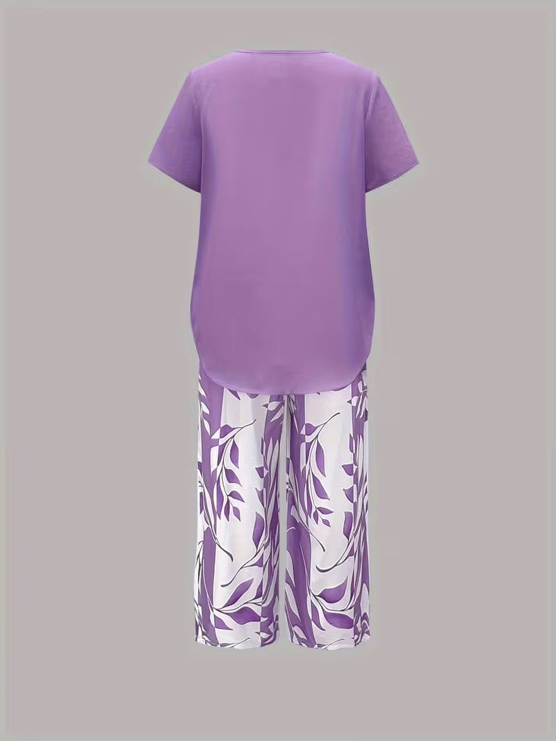 Chic women's leaf print two-piece set. Botanical summer fashion with short sleeve top & relaxed fit pants set.