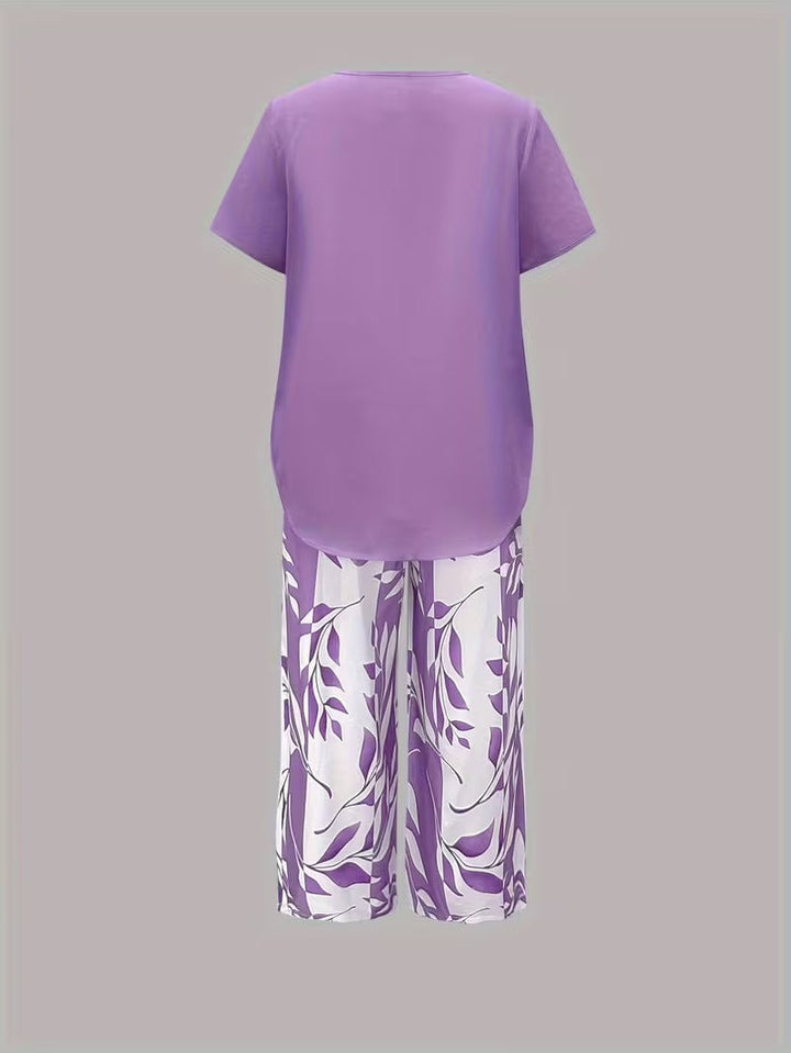 Chic women's leaf print two-piece set. Botanical summer fashion with short sleeve top & relaxed fit pants set.