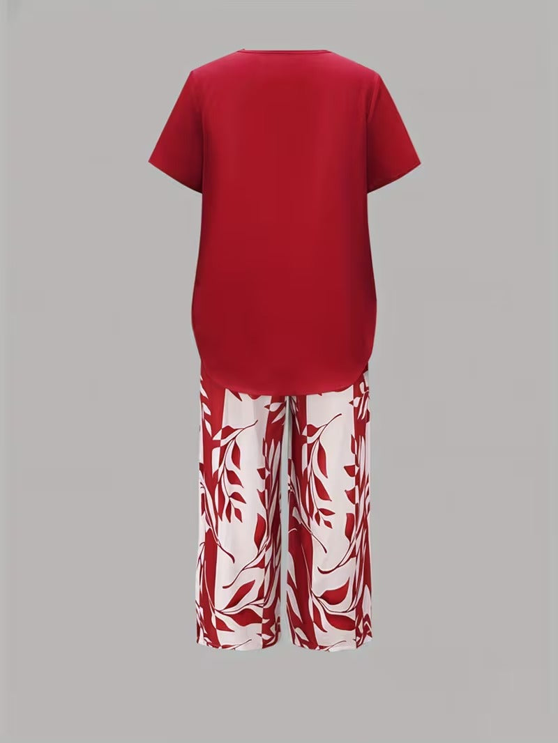 Close-up detail of botanical leaf print on women's two-piece outfit. Short sleeve top fabric & elegant pants.
