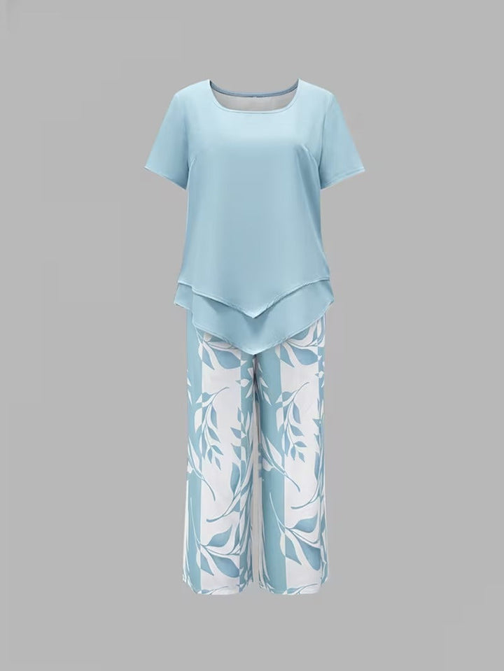 Comfortable women's leaf print two-piece outfit. Relaxed fit short sleeve top & pants for elegant summer fashion.