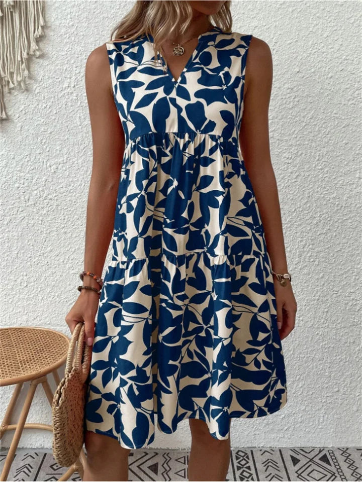 Flattering A-line women's mini dress with stylish leaf print and V-neck, ideal for summer.