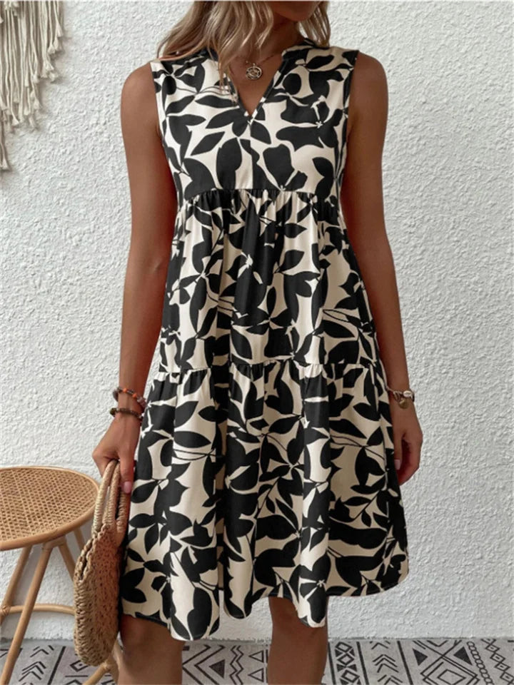 Sleeveless V-neck women's mini dress with vibrant leaf print, a perfect casual summer outfit.