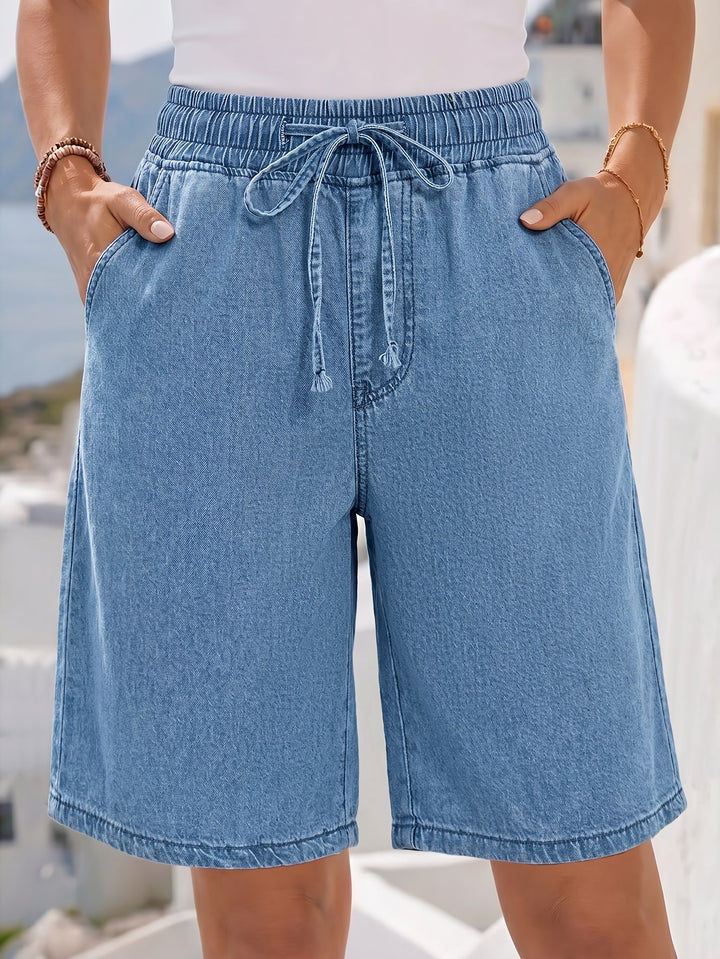 Stylish women's light blue wide-leg denim Bermuda shorts, featuring a comfortable drawstring waist for summer.