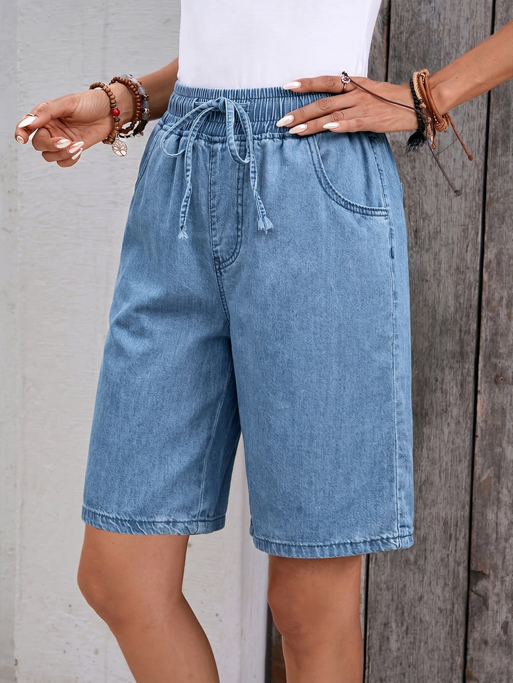 Casual light blue women's denim Bermuda shorts with drawstring waist, ideal for comfortable summer fashion.