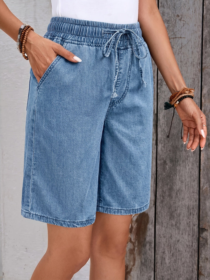 Women's light blue drawstring denim Bermuda shorts. Wide leg, elastic waist. Comfortable casual summer wear.