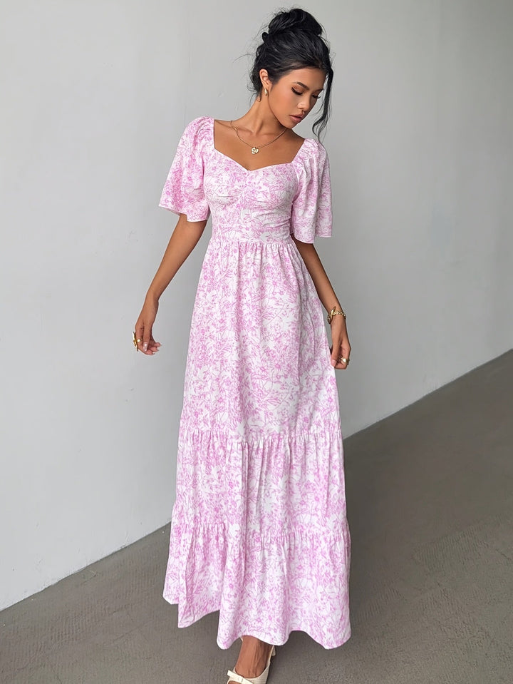 Women's light blue floral maxi dress with sweetheart neckline and tiered skirt, perfect for summer or spring occasions.
