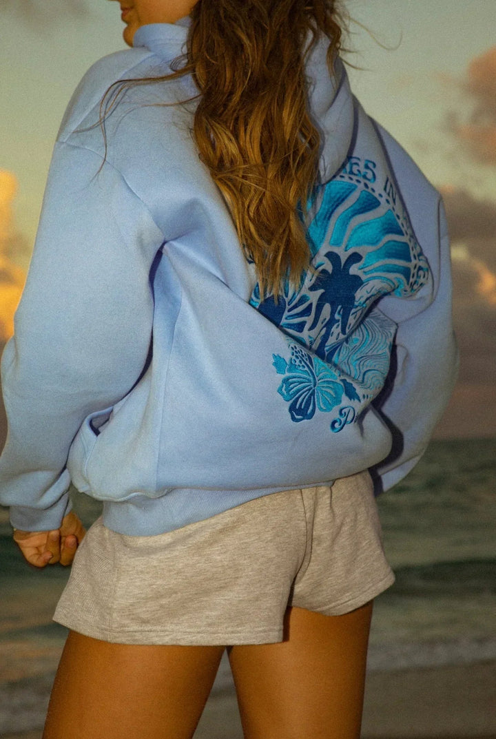 Relaxed fit blue women's hoodie, ideal as a lightweight, breathable layering piece for summer outfits.