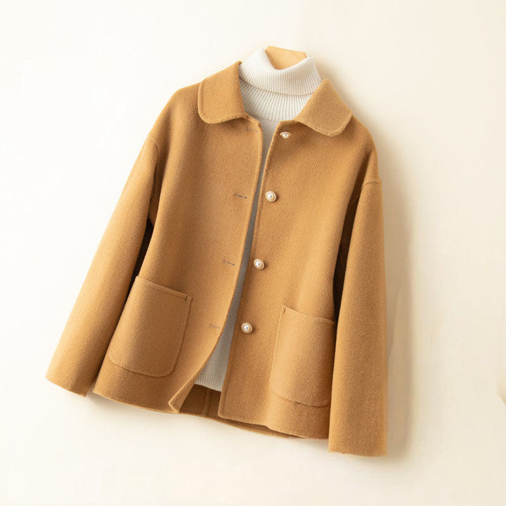 Back view of a women's lightweight cashmere knit jacket, highlighting its smooth elegant drape