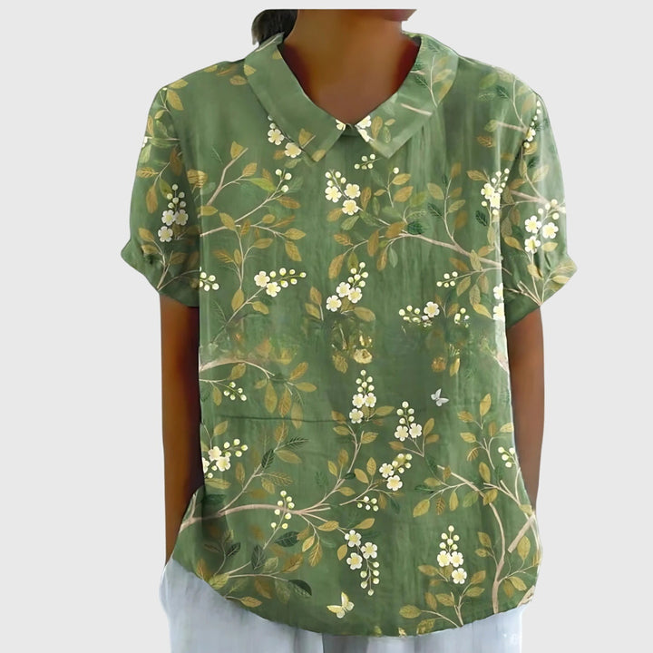Women's lightweight floral blouse on a hanger, ready for comfortable, versatile spring and summer wear.