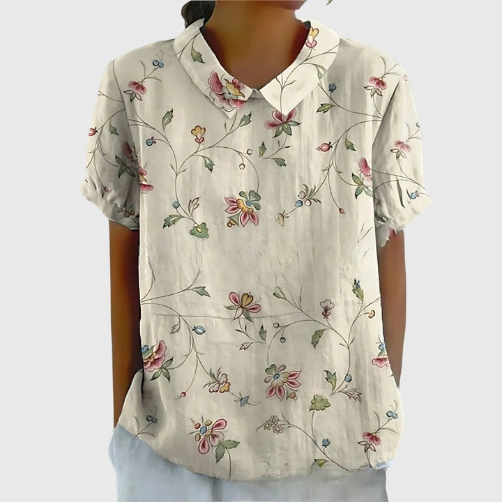 Women's lightweight floral blouse worn outdoors, capturing its relaxed fit and effortless spring style.