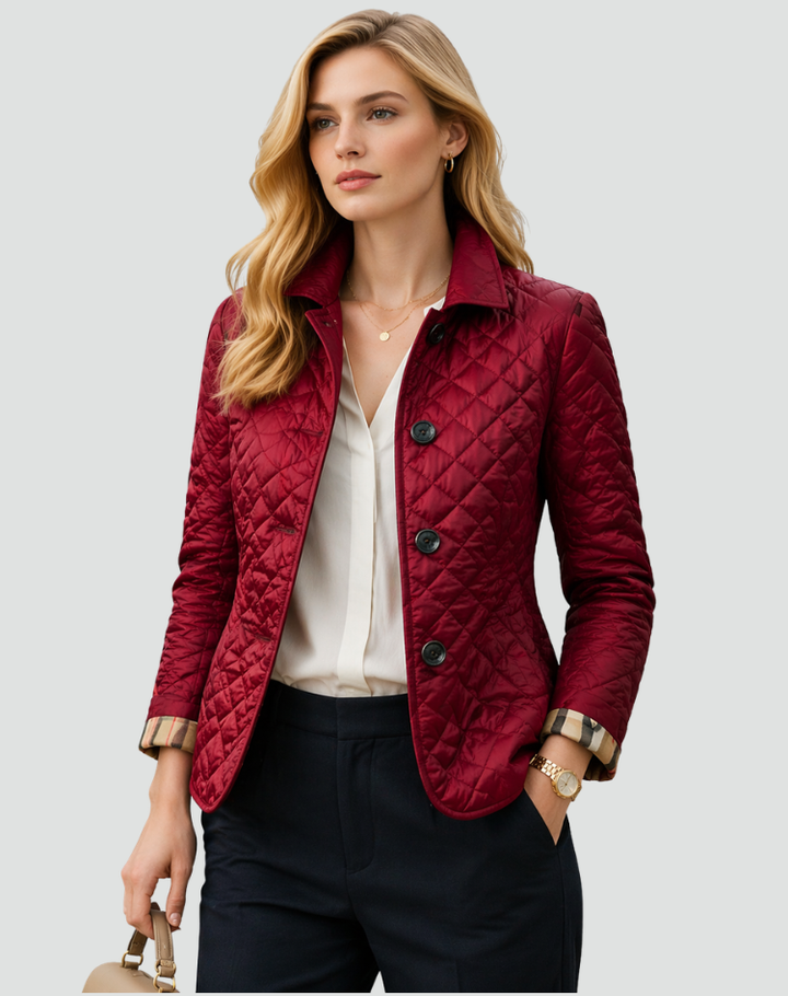 Back view of a women's lightweight quilted jacket, showing its elegant tailored fit & structured design.