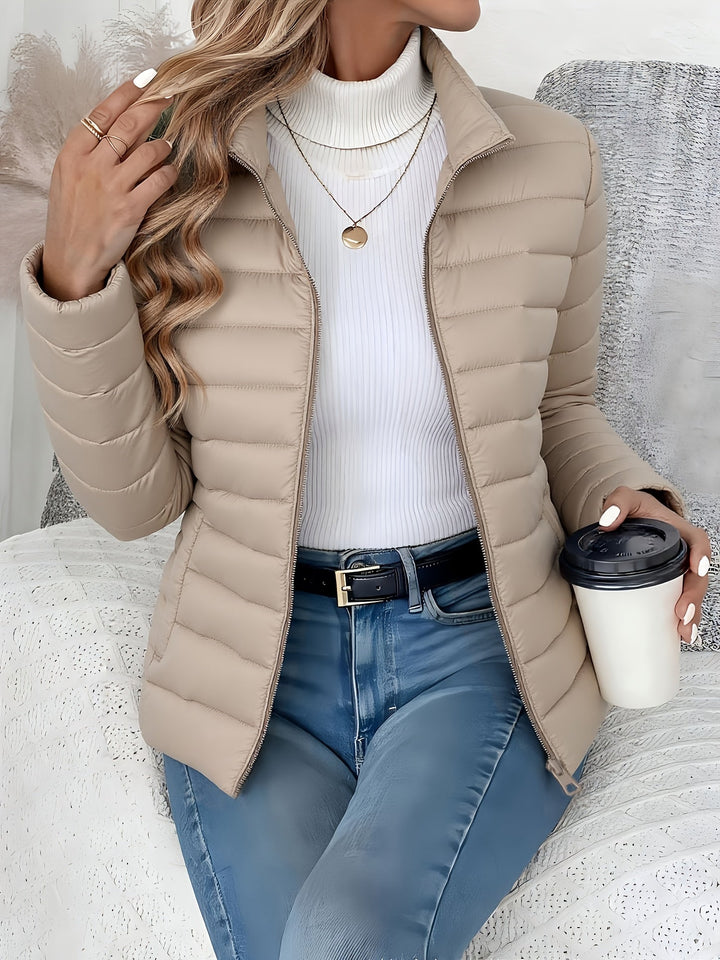 Modern women's quilted puffer coat, lightweight and warm. Elegant zip-up jacket for everyday ladies' fashion.