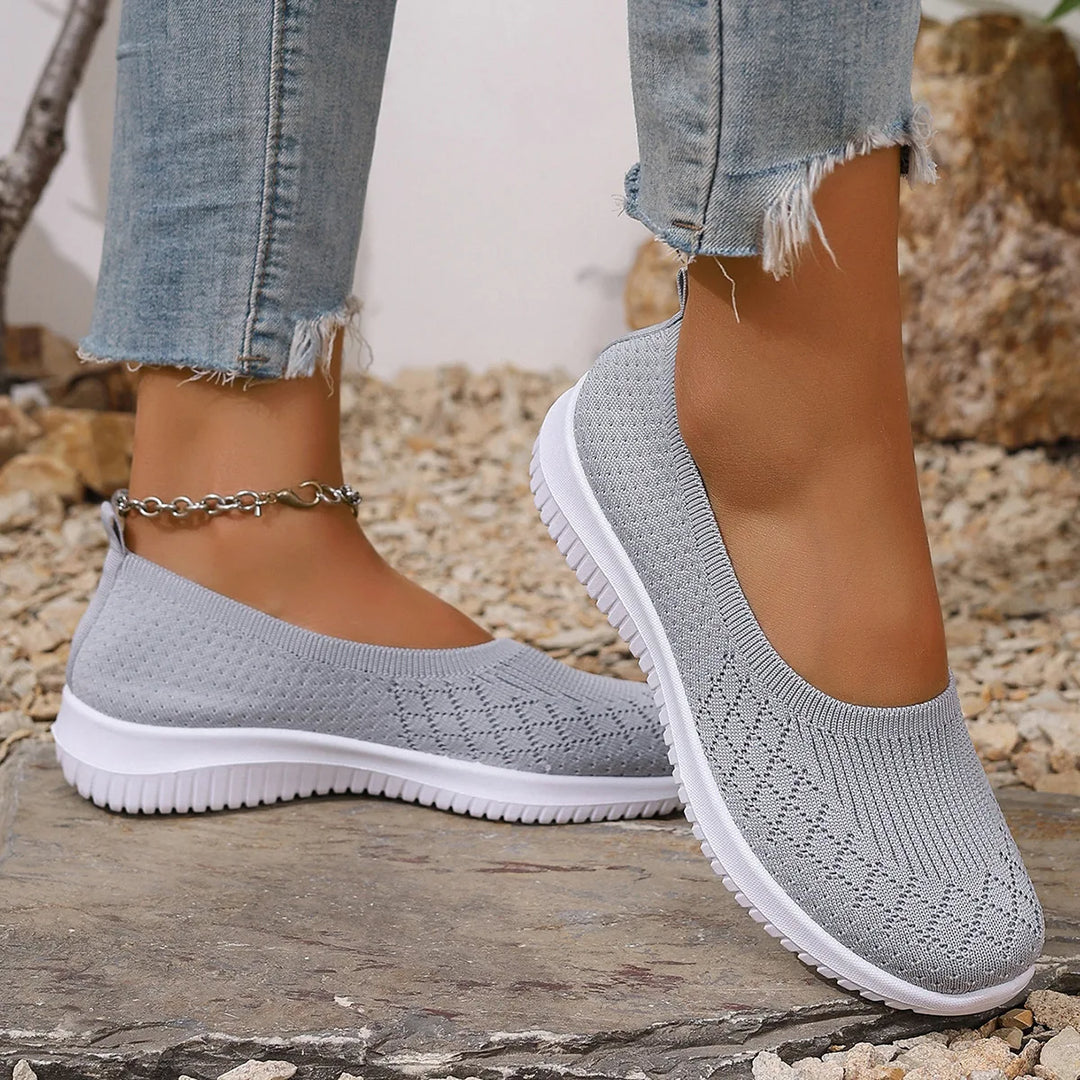 Women's lightweight slip-on walking sneakers in a neutral color, perfect for everyday comfort and travel.