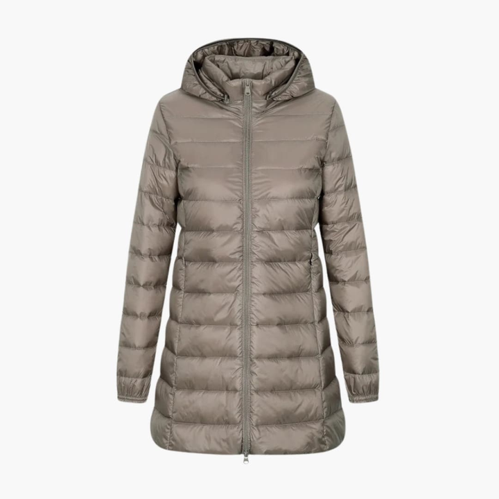 Warm women's long puffer jacket with hood, designed for extreme cold weather. Cozy quilted winter outerwear fashion.
