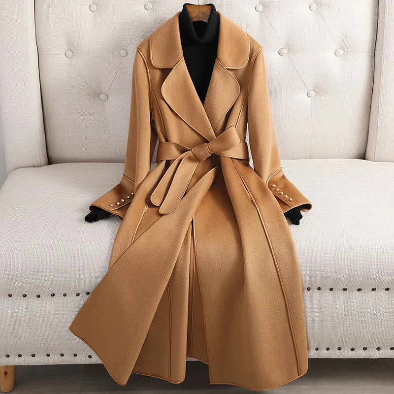 Women's long trench coat with belted waist, tailored fit. Classic style for elegant outerwear in fall & spring.