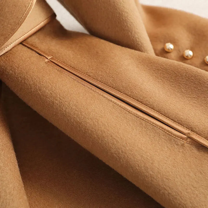 Stylish ladies' long trench coat, belted at waist, tailored for a flattering fit. Classic outerwear for women.