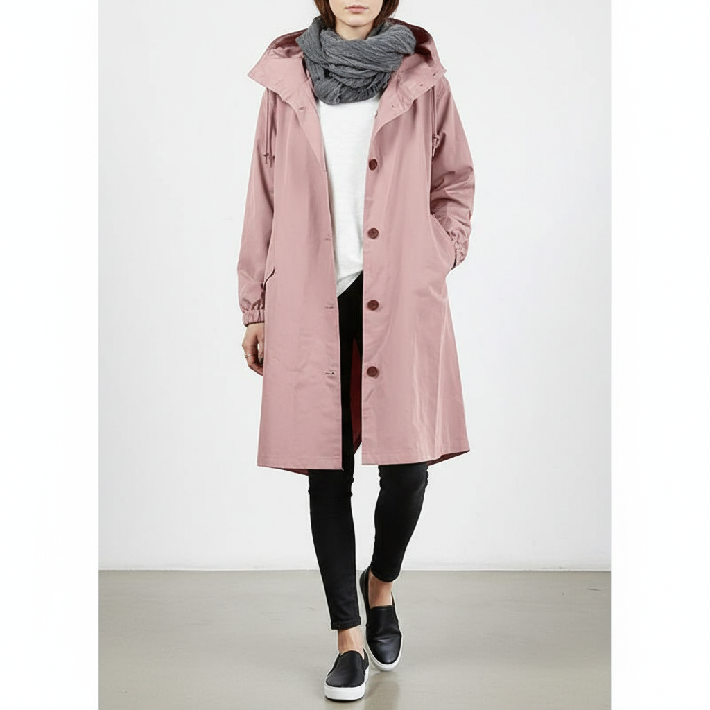 Stylish women's water resistant longline rain jacket with hood, perfect for travel & outdoor wear.