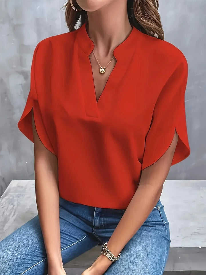Women's versatile loose fit V-neck top, short sleeve, styled casually for comfortable spring fashion.