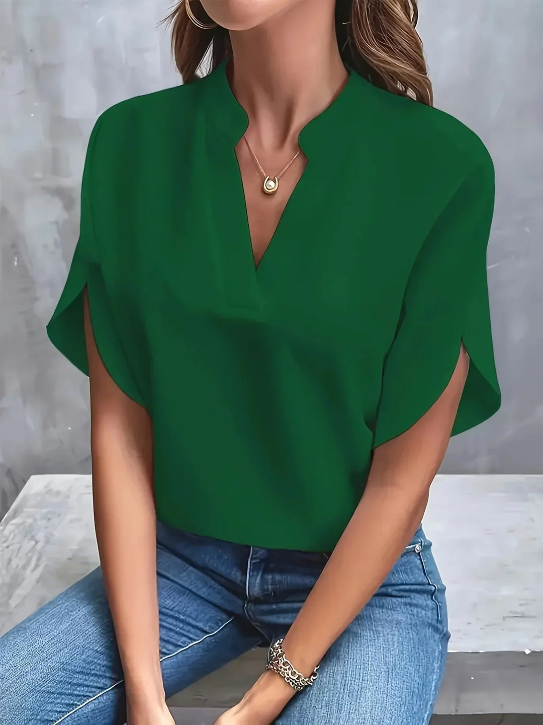 Chic women's short sleeve V-neck blouse, loose fit, offering comfort and elegance for versatile office or casual wear.